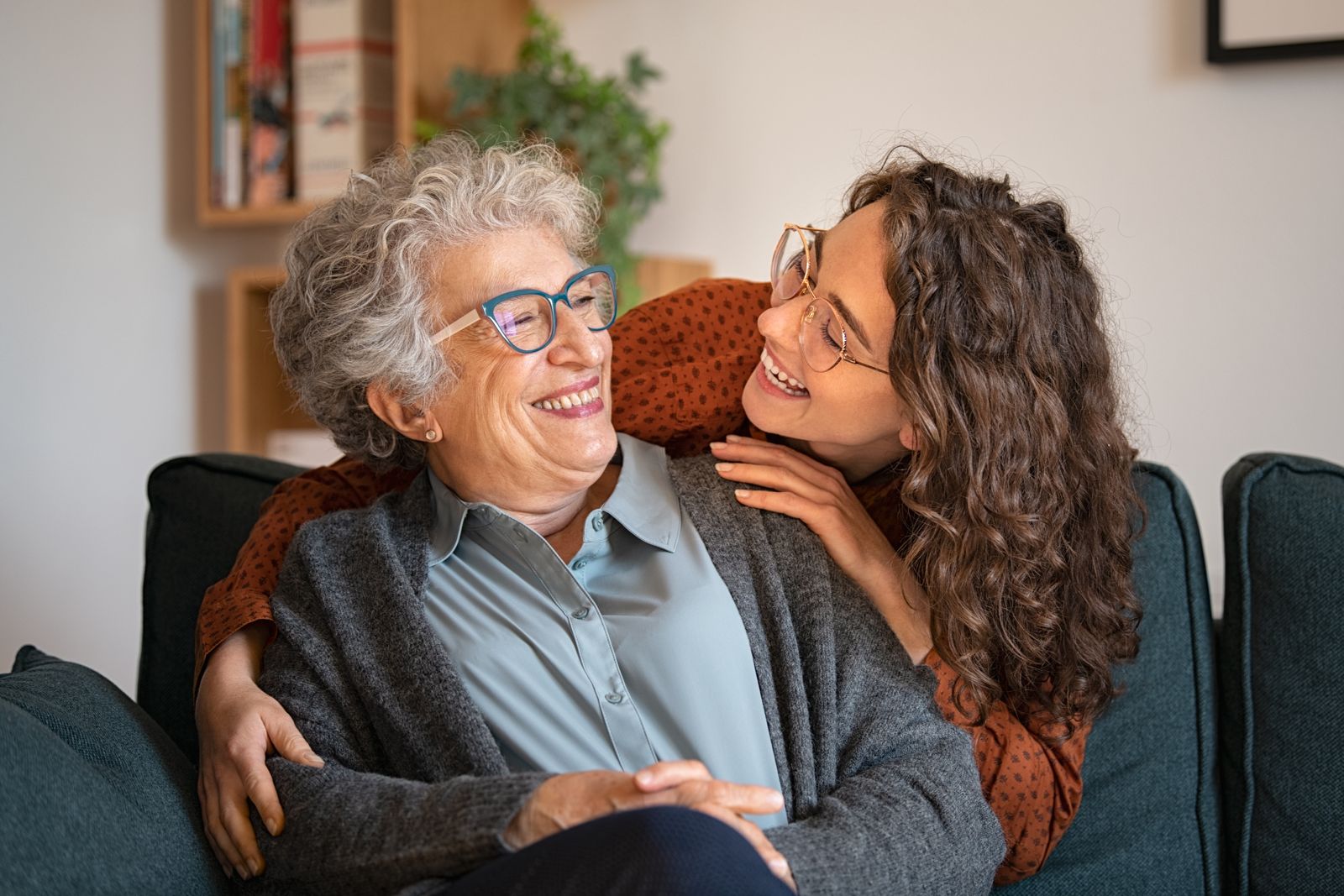 Older woman smiling with her adult daughter.